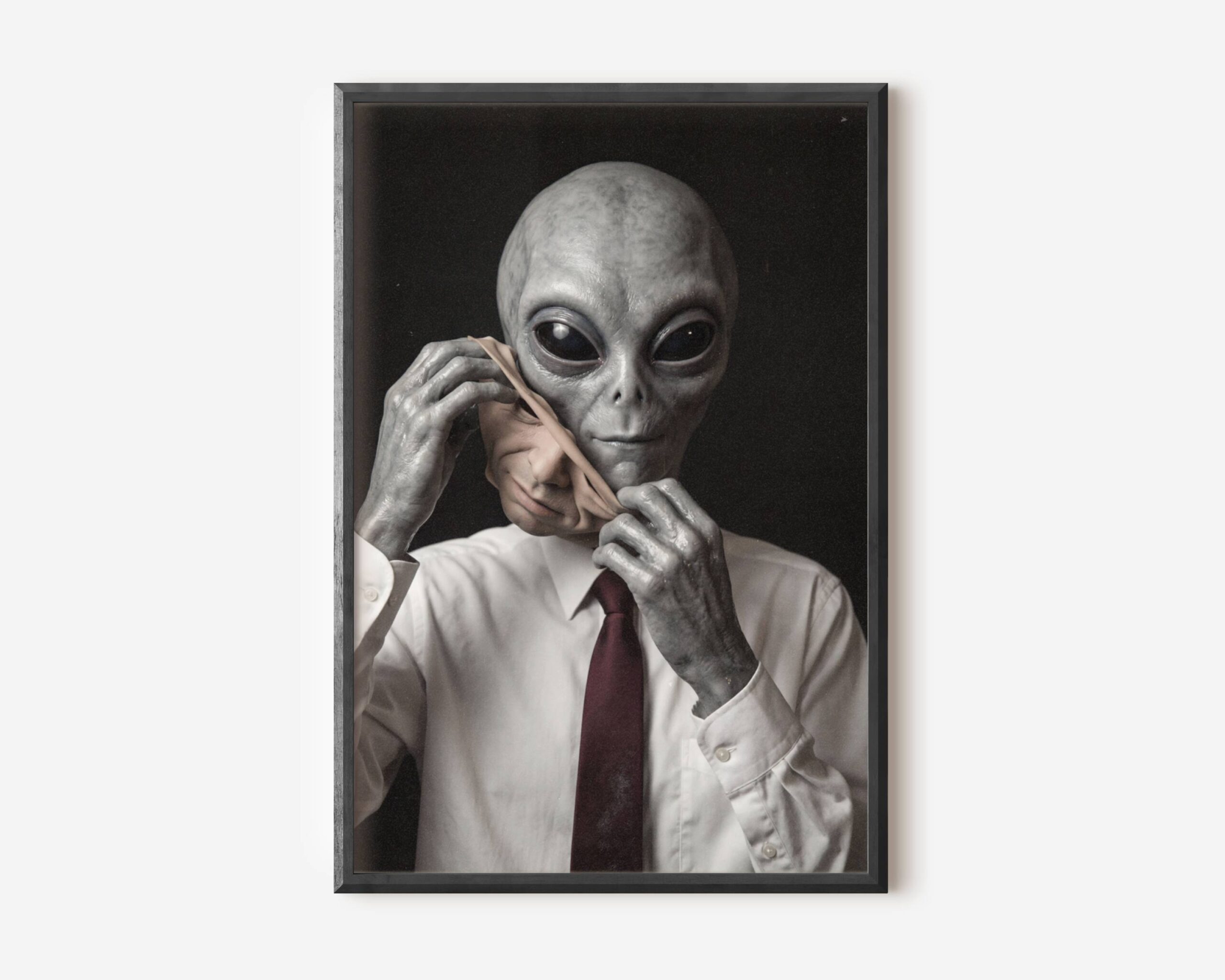 Premium dark concept poster of a grey alien dressed in a white shirt and red tie removing a human face mask, blending corporate satire with dark sci-fi in a striking portrait composition – unframed alien art poster, ufoposter.com