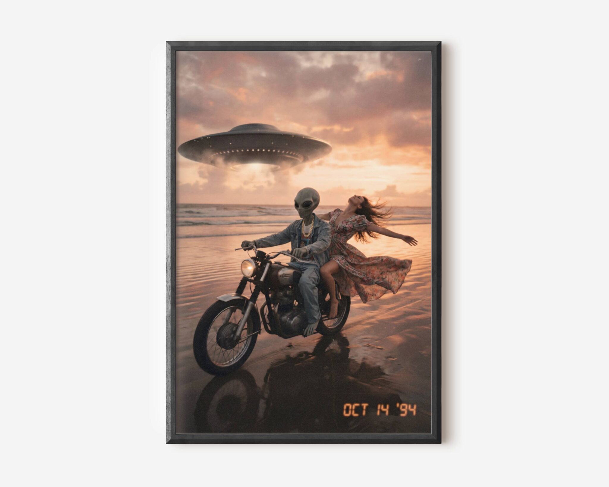 Premium retro sci-fi poster of a grey alien in a denim jacket and gold chain riding a classic motorbike along a wet sunset beach with a laughing woman, a UFO glowing above pink evening clouds – unframed alien art poster, ufoposter.com
