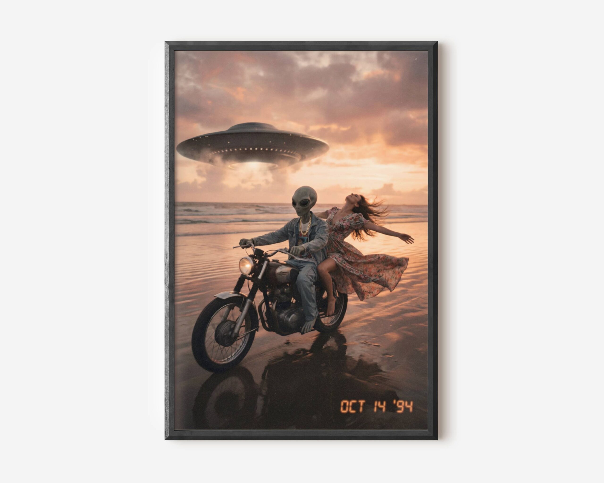 Premium retro sci-fi poster of a grey alien in a denim jacket and gold chain riding a classic motorbike along a wet sunset beach with a laughing woman, a UFO glowing above pink evening clouds – unframed alien art poster, ufoposter.com