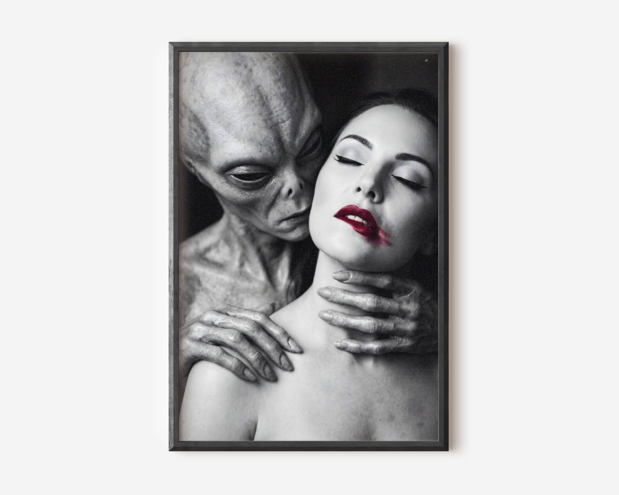 Haunting monochrome portrait of a grey alien figure placing long fingers on a woman's shoulders as she closes her eyes, her red lips the only color in the composition – unframed dark sci-fi art poster, ufoposter.com