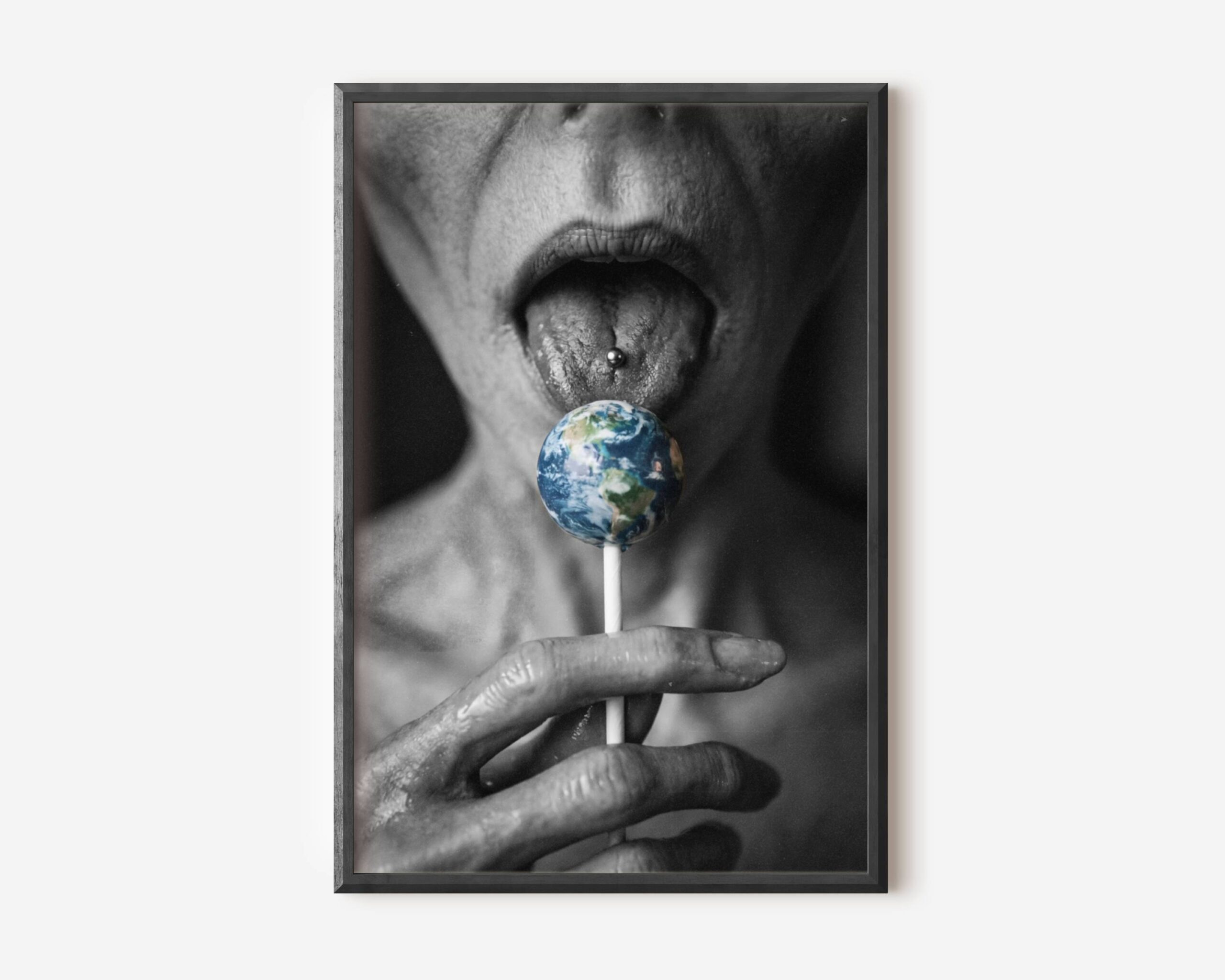 Premium dark concept poster of a grey alien licking a lollipop shaped like planet Earth, combining sci-fi humour with dark surreal aesthetics in a striking close-up composition – unframed alien art poster, ufoposter.com