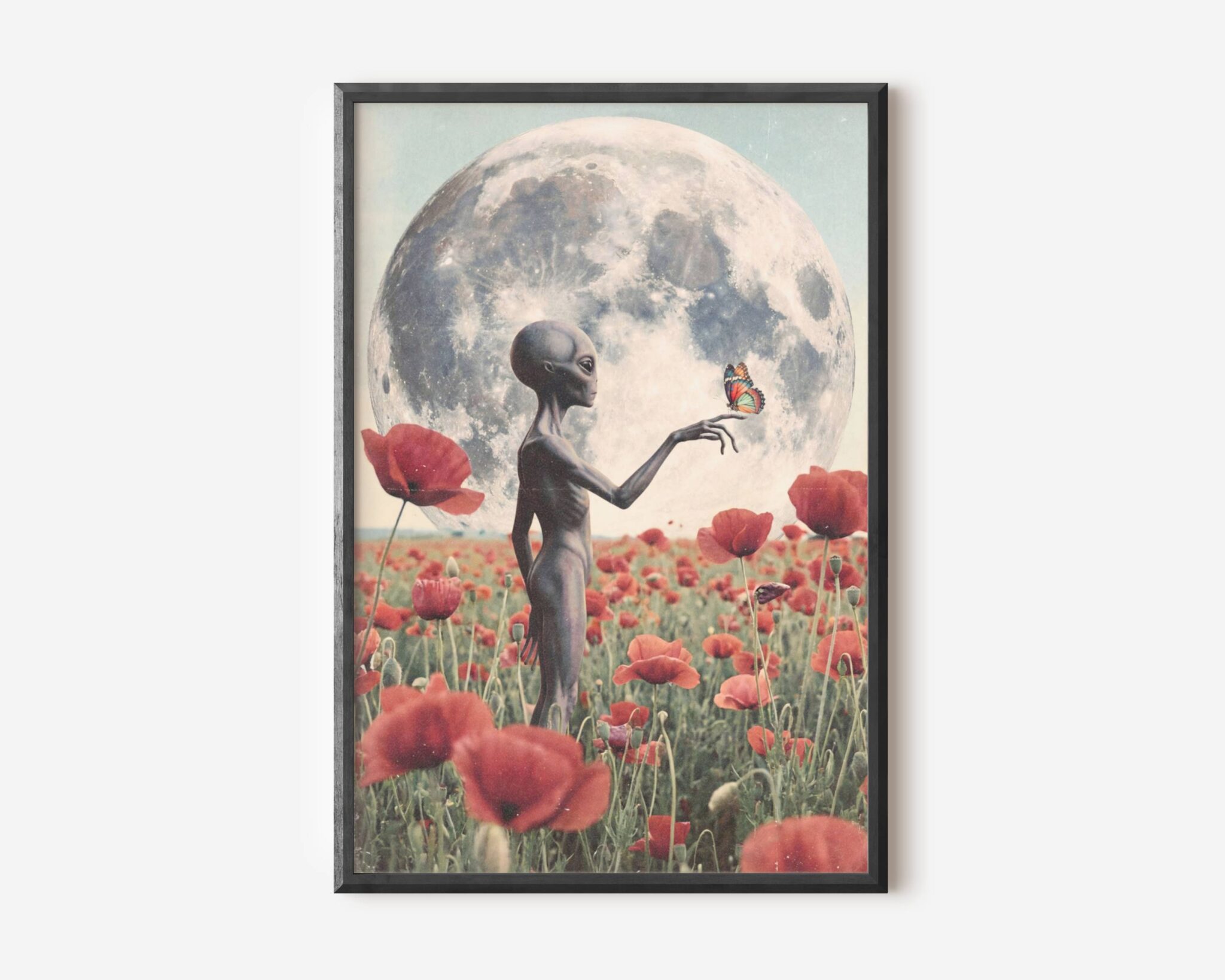 Premium dreamy retro sci-fi poster of a grey alien in a vast red poppy field beneath an enormous full moon, gently holding a colourful butterfly on one outstretched finger in a beautifully romantic and atmospheric composition — distinctive alien wall art at its most tender – unframed alien art poster, ufoposter.com