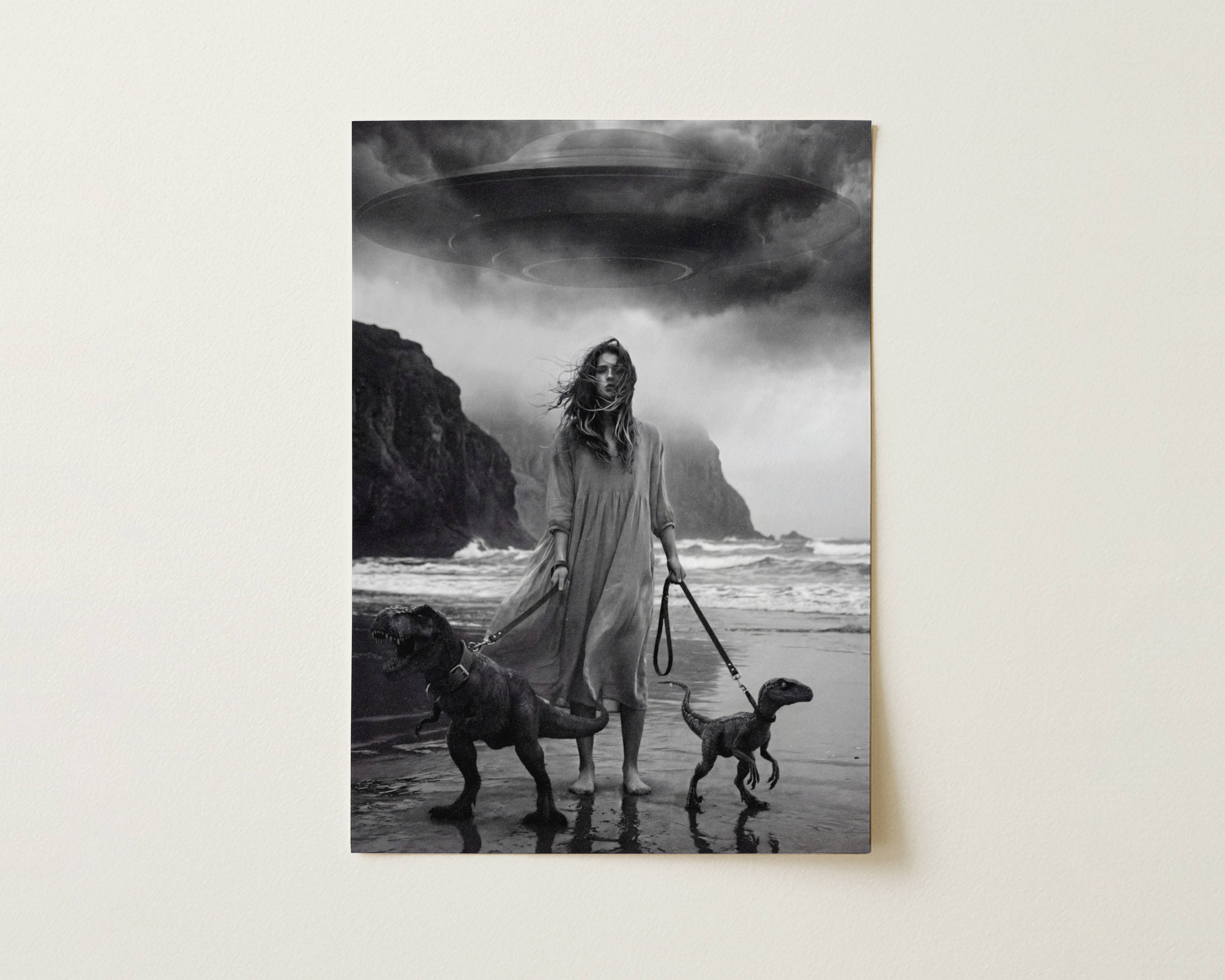 Black and white fine art print photographed flat as a sheet of paper, showing a woman in a long flowing dress on a wild stormy beach with windswept hair and dark cliffs in the background. The flat lay highlights the rich tonal contrast and fine detail of this cinematic art poster.