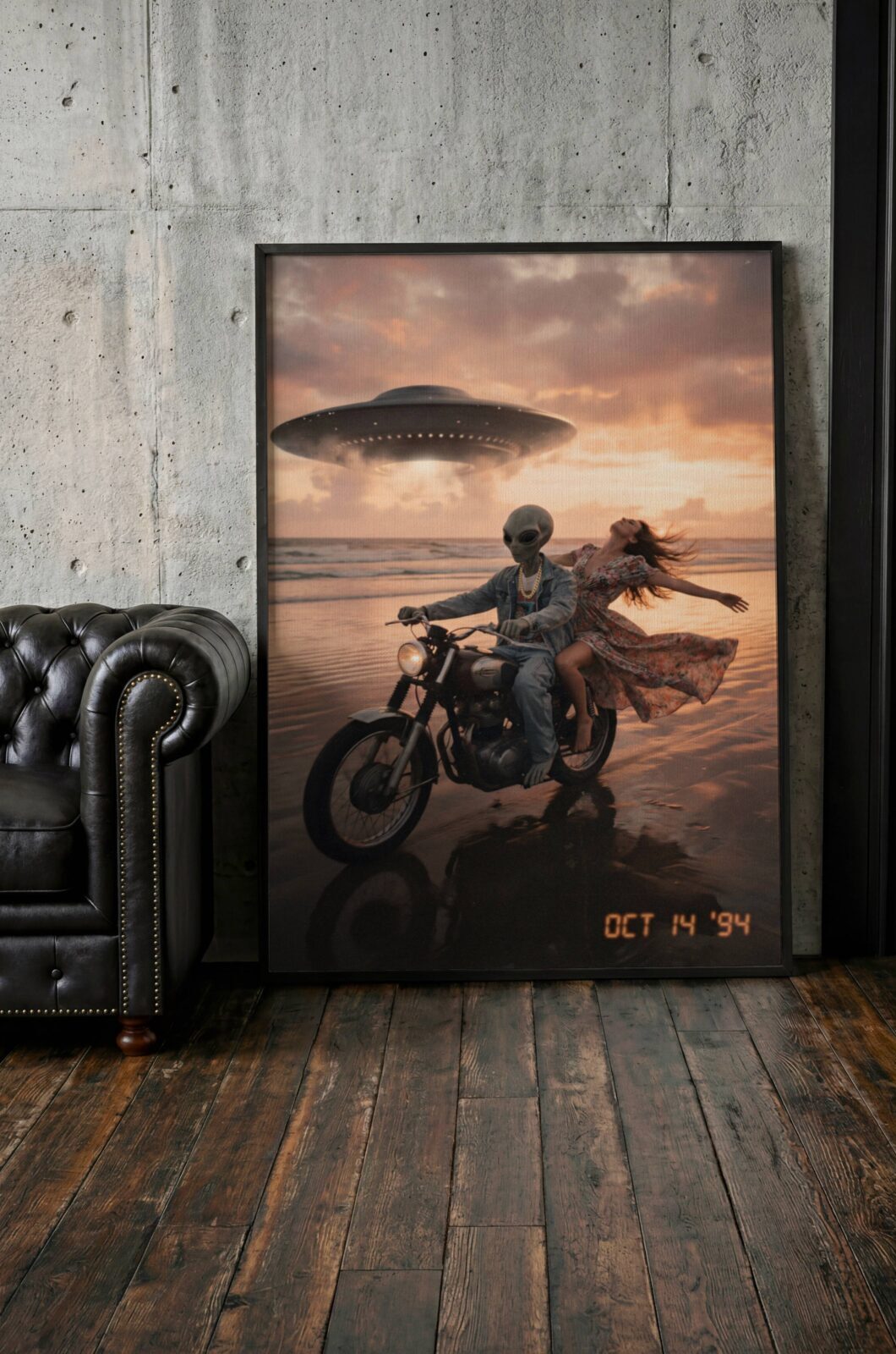 Golden sunset retro artwork of a grey alien biker in denim and gold chain riding along a reflective wet beach with a laughing woman and a glowing UFO above pink evening clouds – unframed retro alien art poster for living room, ufoposter.com