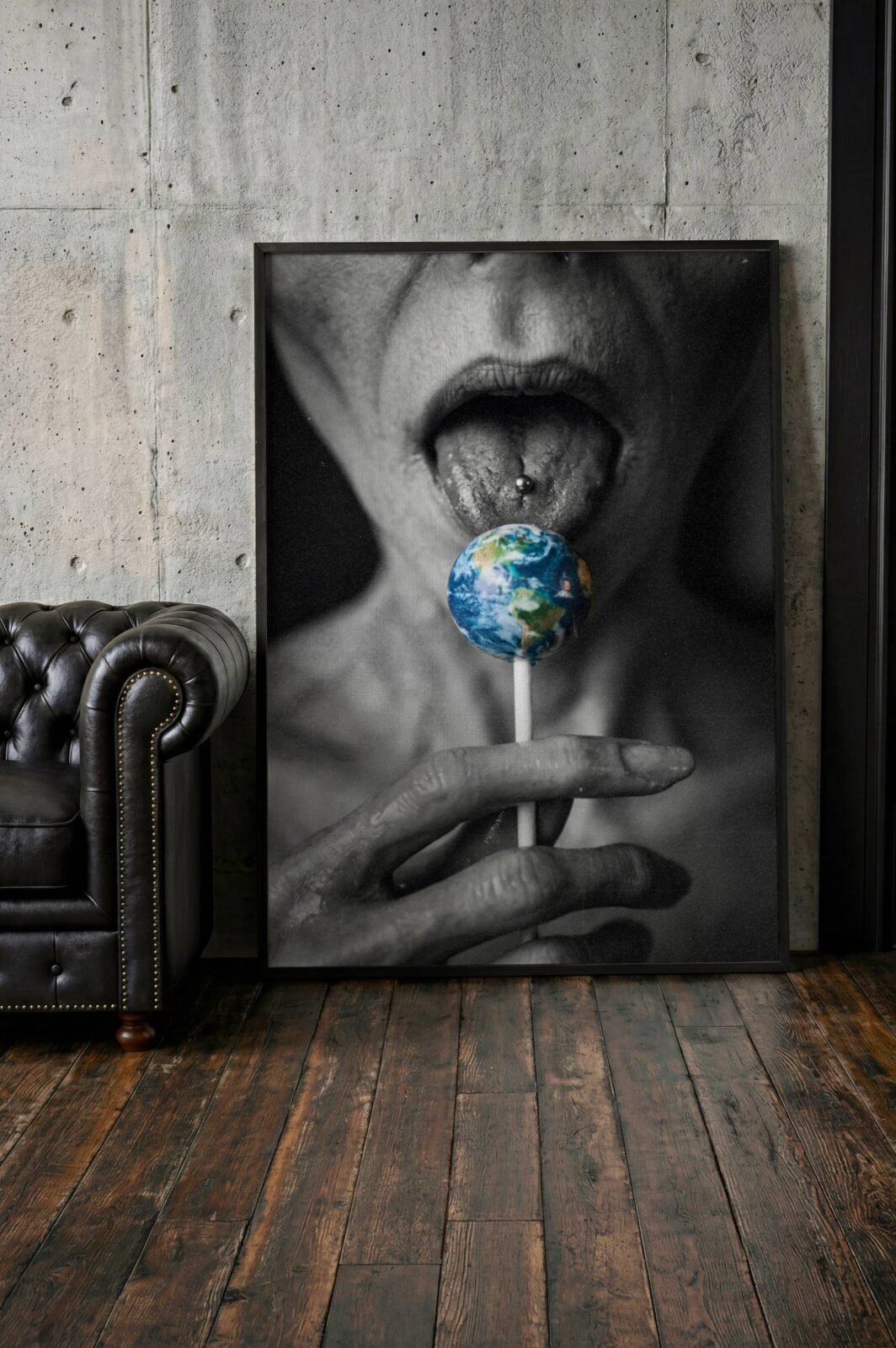 Striking dark close-up artwork of a grey alien licking a lollipop shaped like planet Earth held in long alien fingers – unframed dark alien wall poster, ufoposter.com