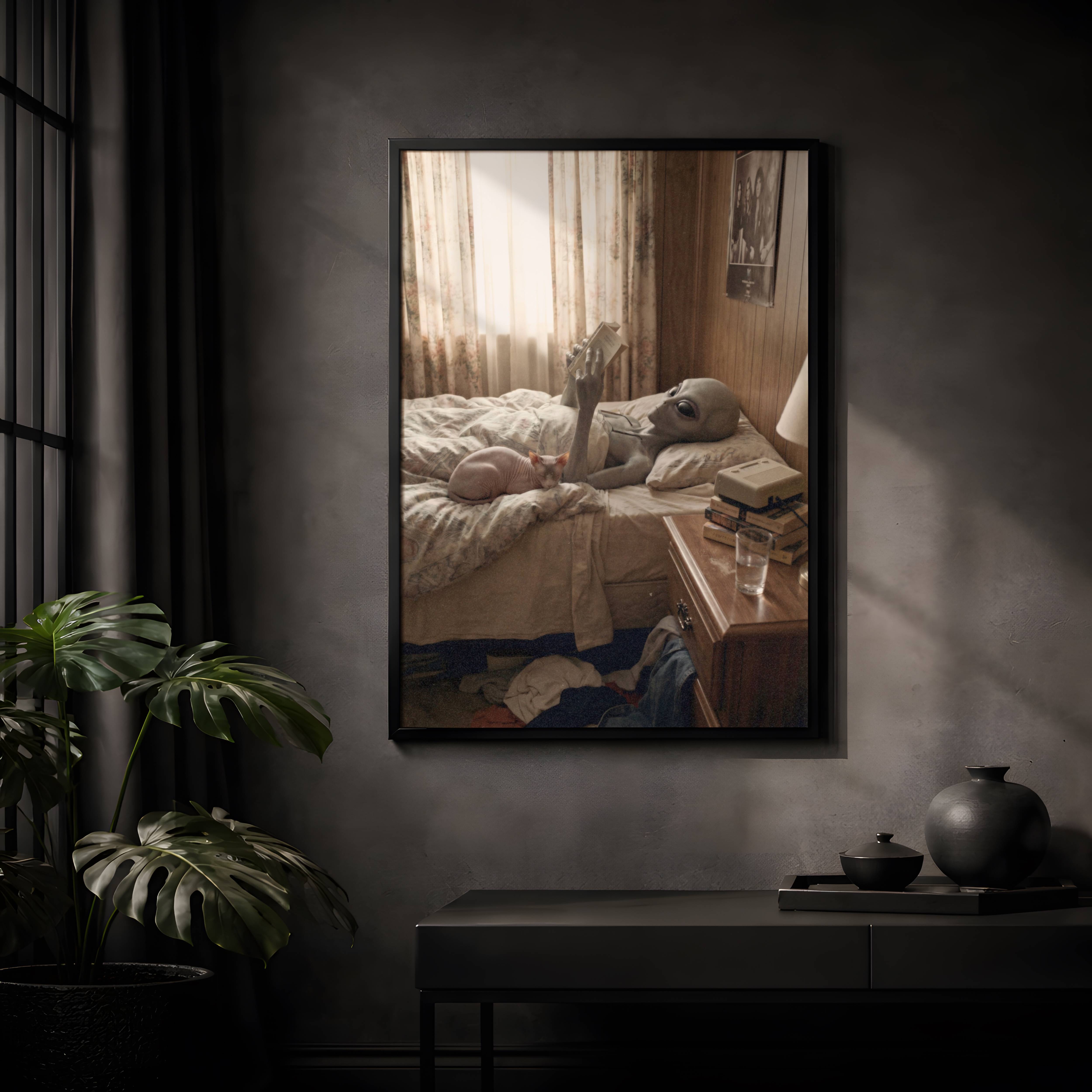 Warm vintage-toned retro artwork of a grey alien lying on a rumpled bed reading a book with a sphynx cat curled beside him, VHS tapes and a glass of water on the bedside table in a cosy wood-panelled room – unframed funny alien wall poster, ufoposter.com