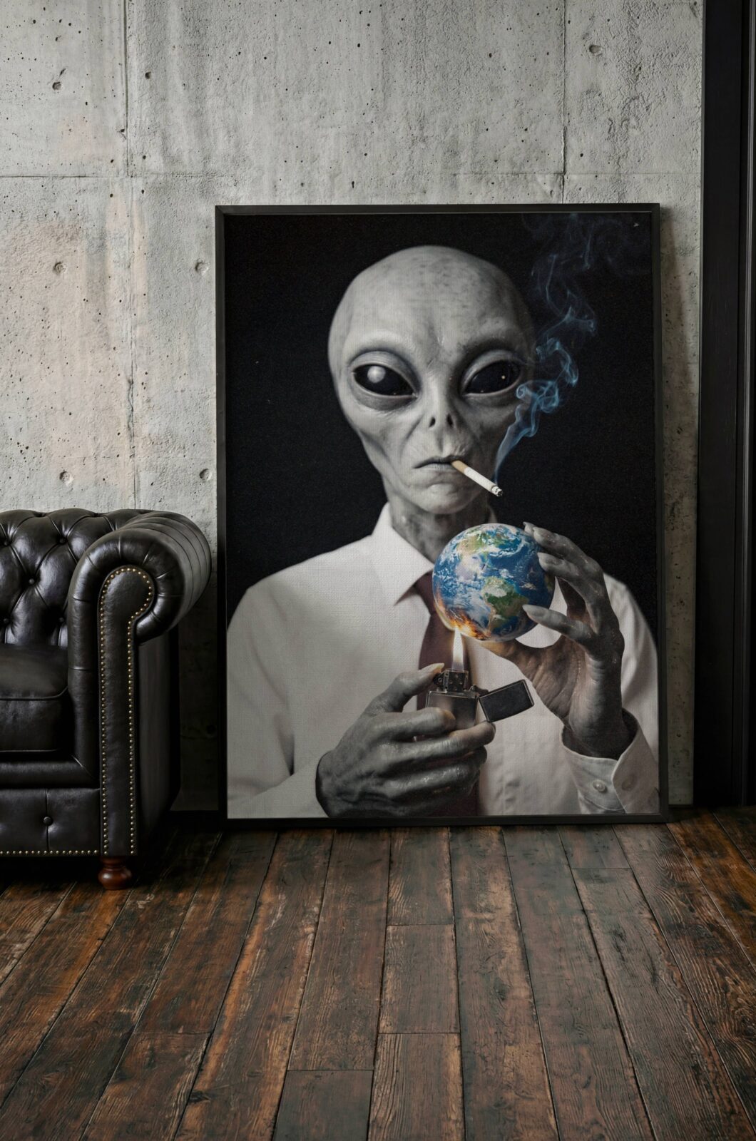 Dark portrait of a suited grey alien smoking a cigarette while setting planet Earth alight with a lighter – unframed dark alien wall poster, ufoposter.com