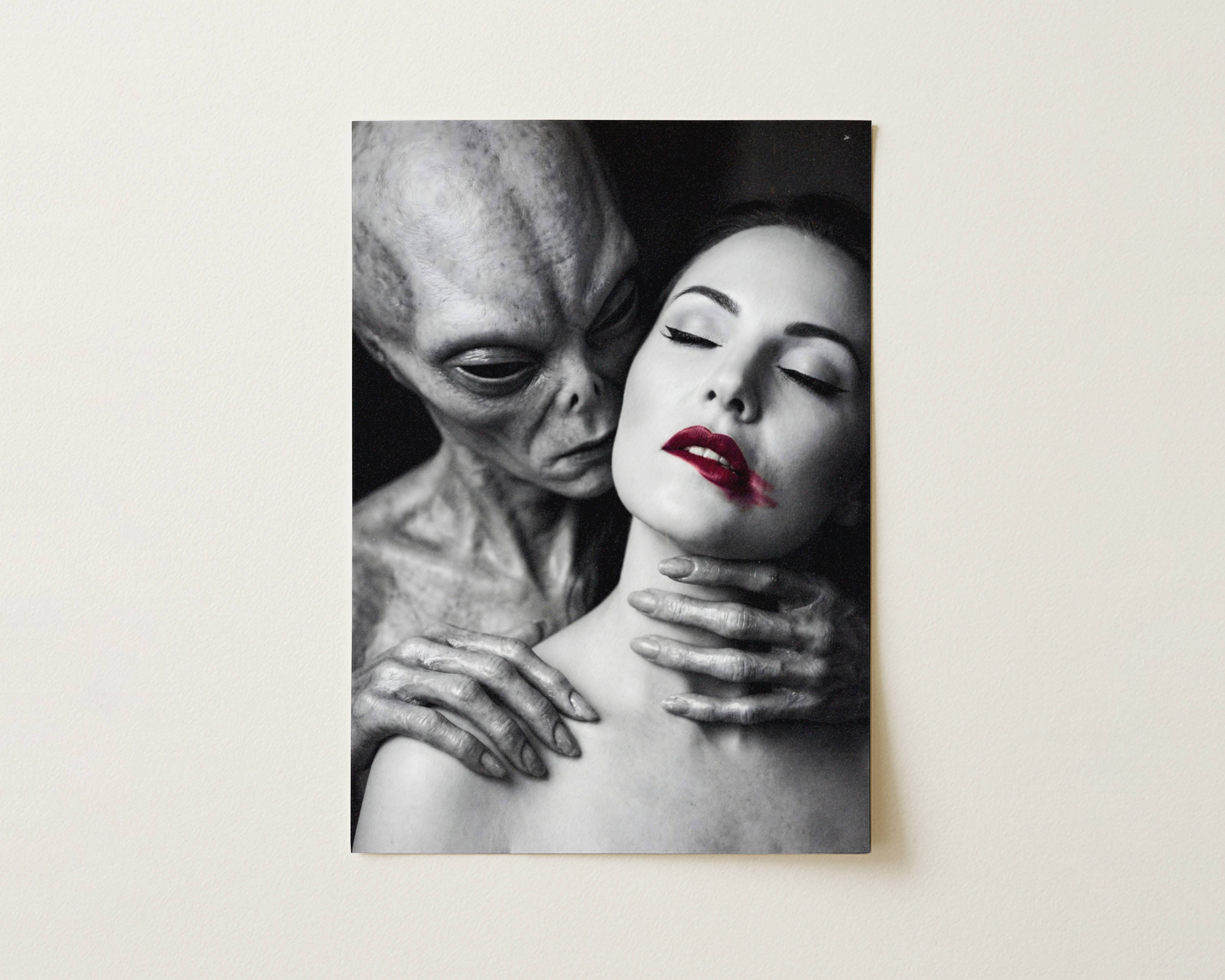 Striking dark artwork depicting an eerie grey alien looming over a serene woman with bold red lips in an intimate noir-style portrait – unframed alien wall poster, ufoposter.com
