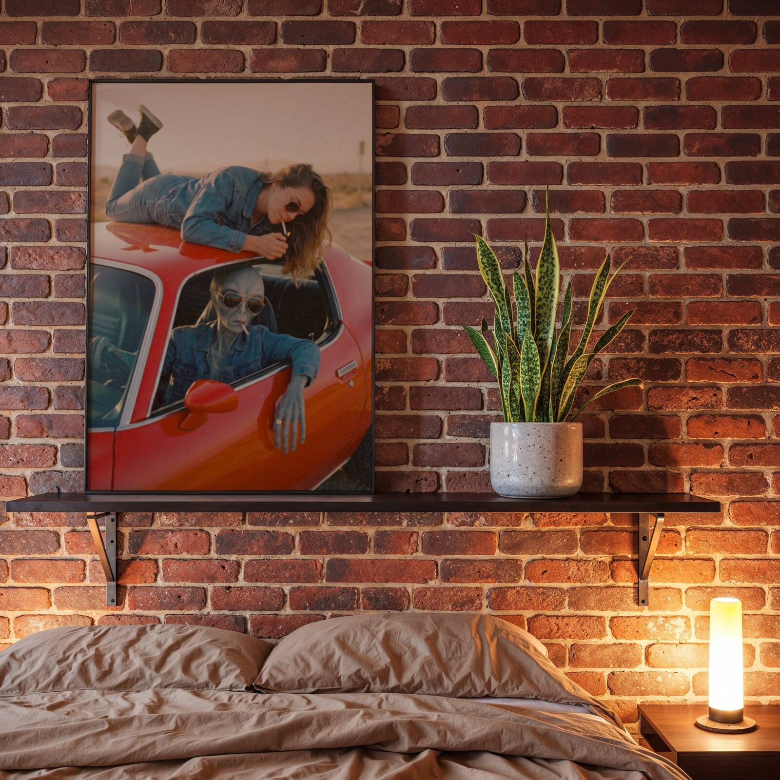 Warm retro-toned artwork of a cool grey alien in aviator sunglasses and denim jacket sharing a cigarette moment with a carefree woman on a vintage red car in a golden desert landscape – unframed retro sci-fi poster for bedroom decor, ufoposter.com