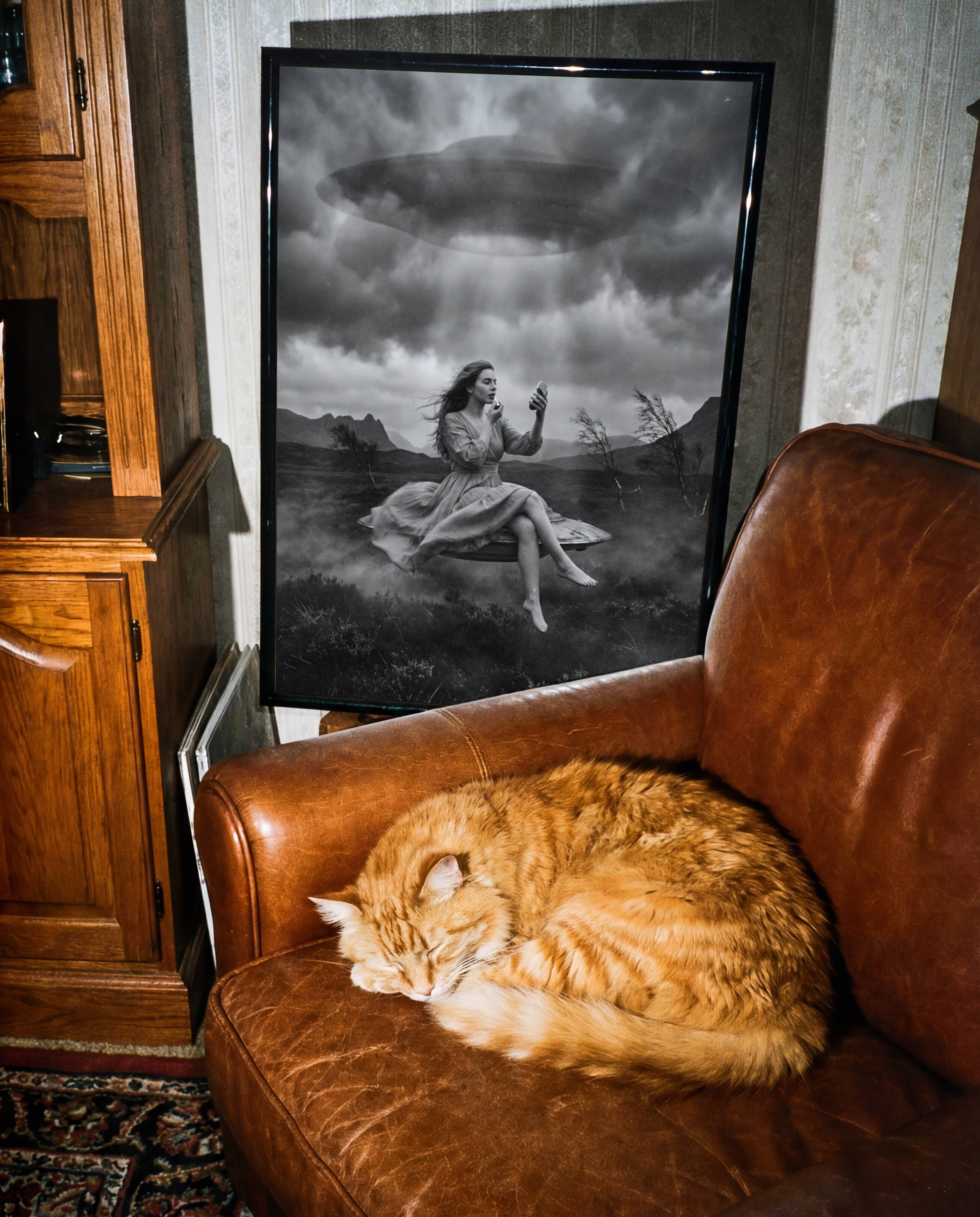 Black and white fine art print of a woman calmly doing her makeup while levitating above a dark moorland under a massive hovering UFO and stormy clouds, displayed in a study or home library, adding a visually arresting and thought-provoking surreal quality to an intellectual interior.