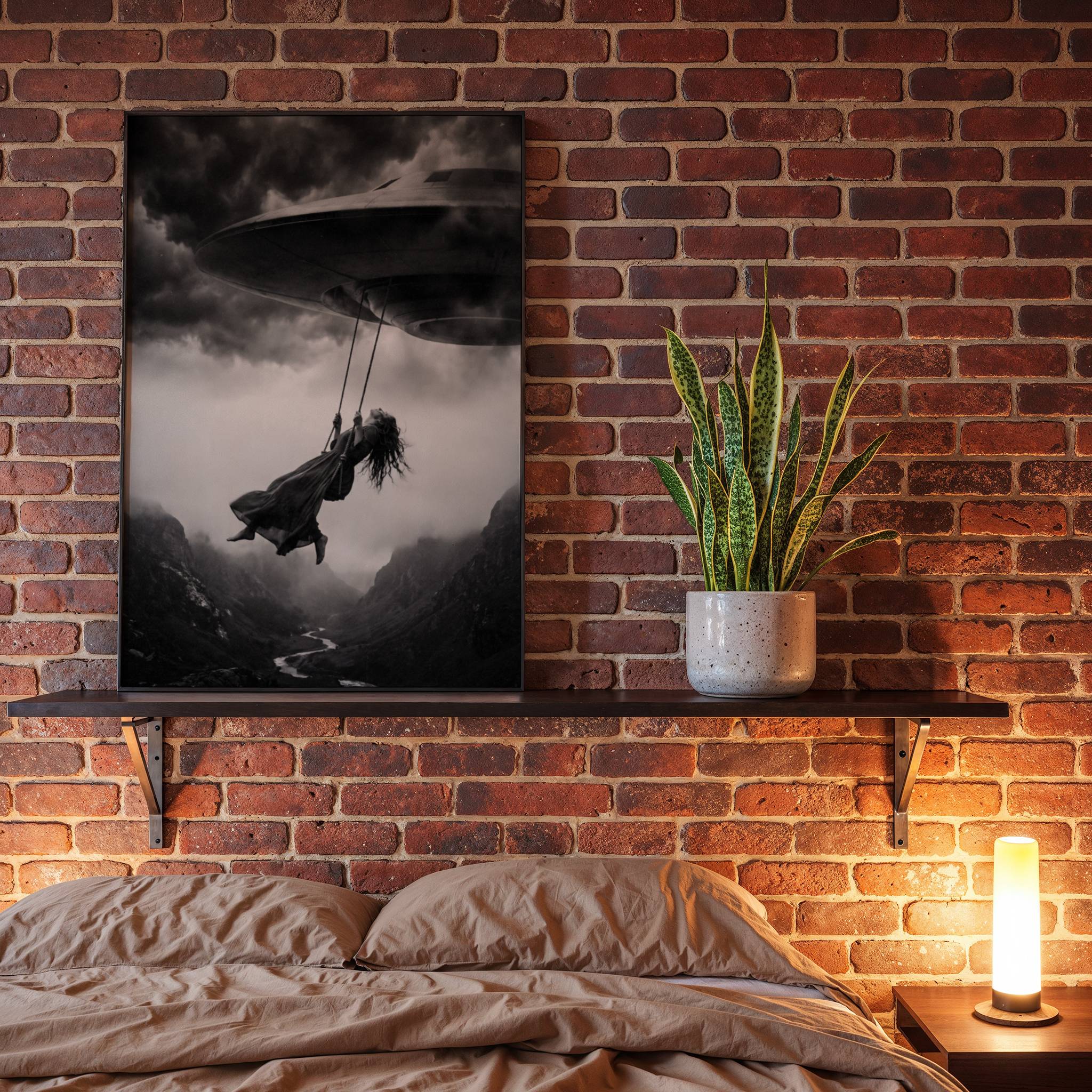 Black and white fine art poster of a woman suspended on a rope swing beneath a UFO over a misty mountain canyon, displayed in a bedroom setting as a striking and atmospheric piece of wall decoration.