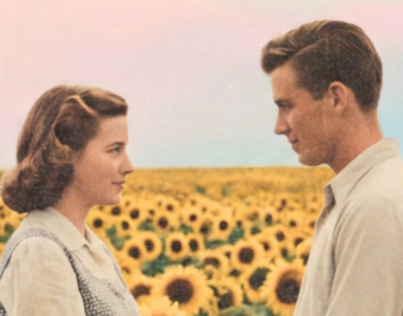 Intimate warm close-up of a 1950s couple's hands clasped together among golden sunflower blooms, soft pastel sky with Saturn's rings and a small UFO visible above the sunflower field behind them – unframed retro romantic collage detail poster, ufoposter.com