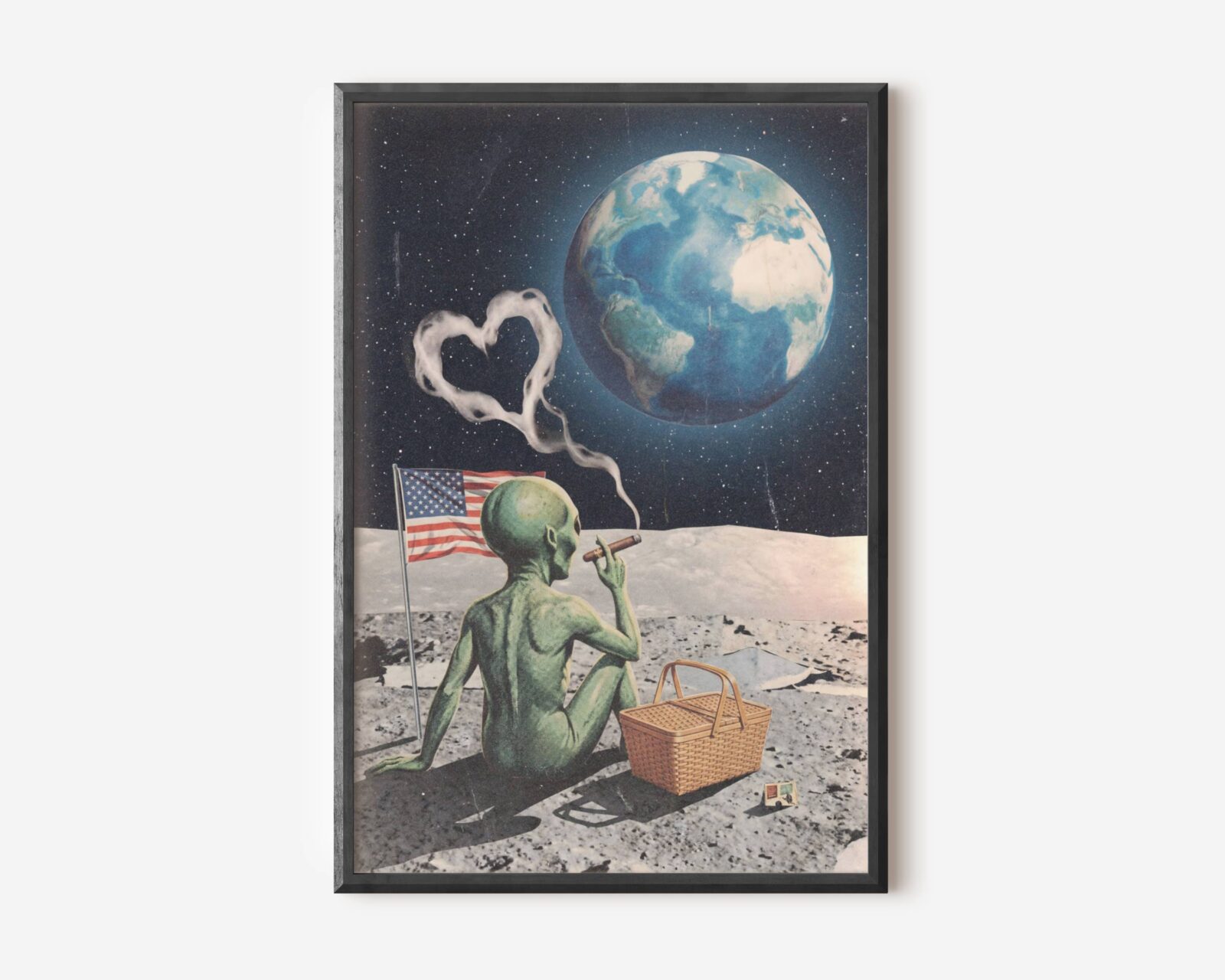 Premium funny retro collage poster of a green alien cross-legged on the lunar surface smoking a cigar as heart-shaped smoke drifts into a starry sky, an American flag and picnic basket beside him and planet Earth glowing blue above — bold, dark and brilliantly funny retro sci-fi collage wall art – unframed funny retro moon collage poster, ufoposter.com