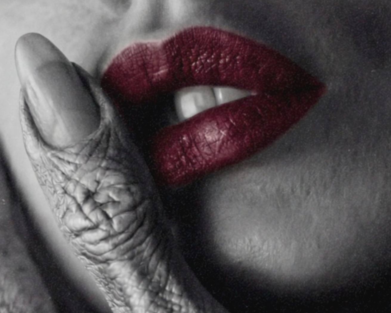 Intense dark monochrome macro close-up of a deeply textured grey alien finger resting on a woman's cheek, her vivid red lips the single bold colour accent in an otherwise stark black and white cinematic composition – unframed dark alien portrait poster, ufoposter.com