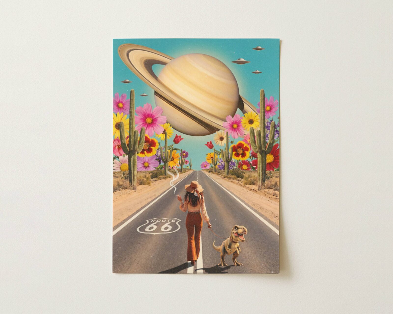 Flat print vibrant colourful retro collage of a bohemian woman walking a baby dinosaur on a leash down Route 66 beneath an enormous Saturn and fleet of UFOs, giant wildflowers and towering cacti lining the desert highway — high quality unframed flat poster print, ufoposter.com