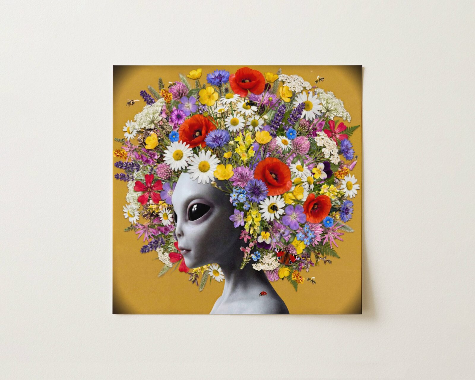 Flat print bold vibrant surreal portrait of a grey alien crowned with an extraordinary explosion of wildflowers — poppies, daisies, cornflowers and lavender — against a warm golden ochre background with bees and a peacock butterfly — high quality unframed flat poster print, ufoposter.com