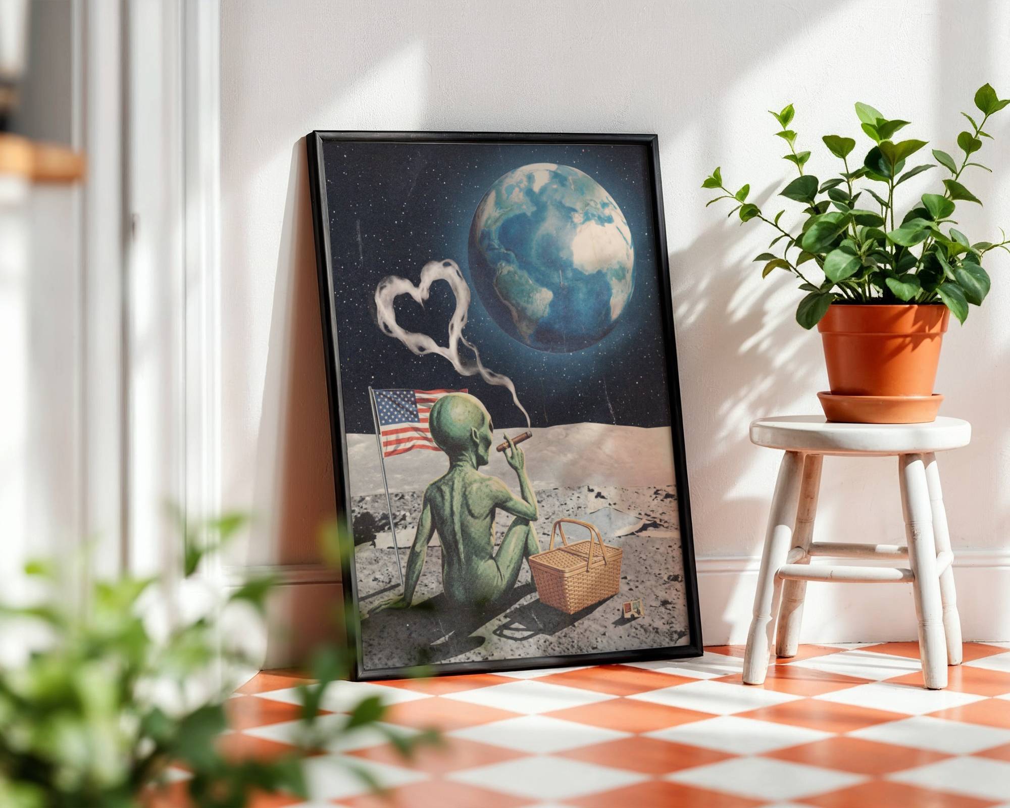 Bold dark retro collage of a green alien on the lunar surface smoking a cigar with heart-shaped smoke curling upward, an American flag and picnic basket beside him and a glowing blue Earth filling the starry sky — hilarious and distinctive funny kitchen poster – unframed retro collage art for kitchen, ufoposter.com