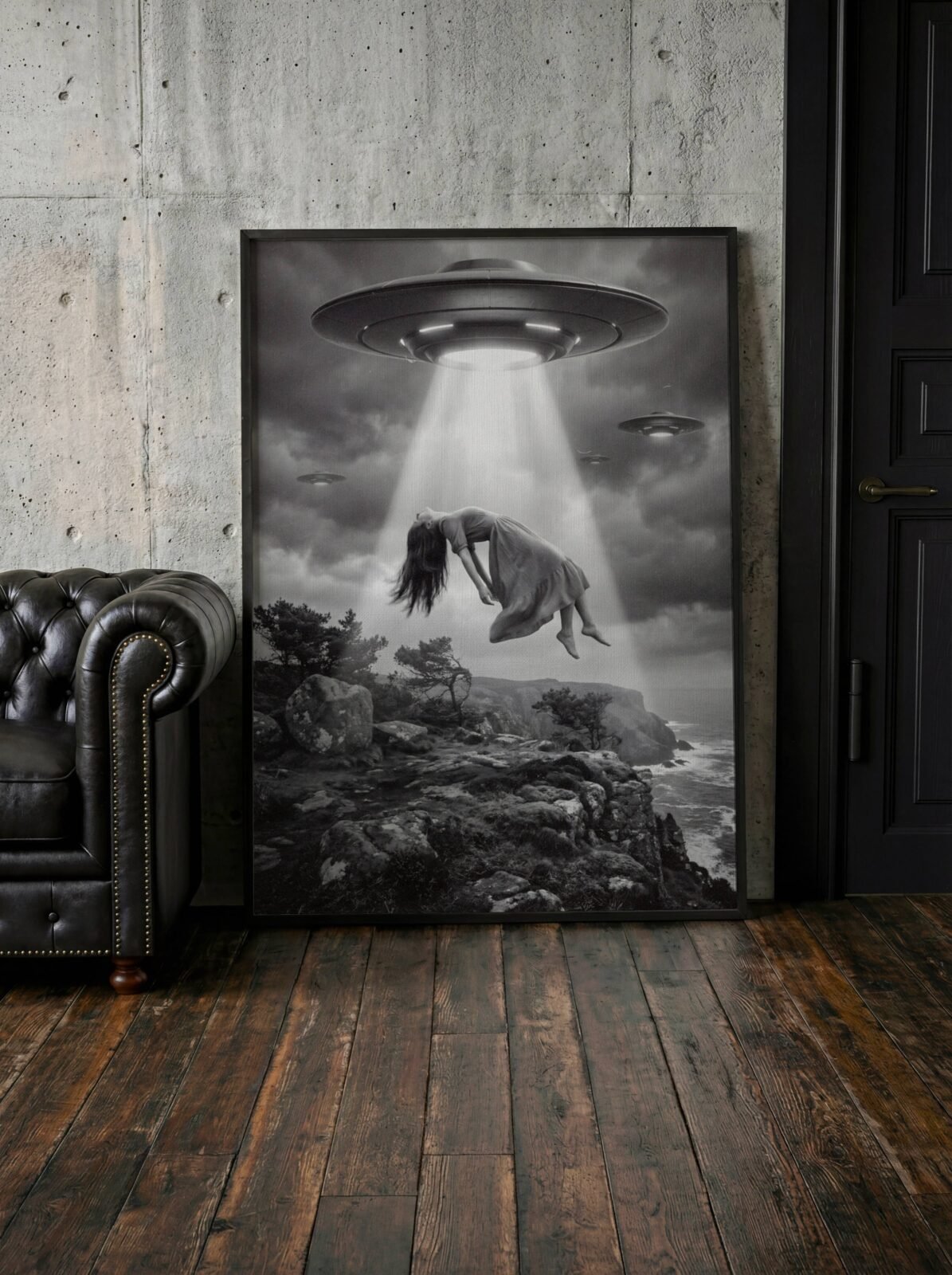 Dramatic black and white surreal artwork of a woman floating weightlessly in a blinding UFO beam above a rocky coastal clifftop, two more spacecraft in heavy storm clouds and a churning grey sea below — a hauntingly beautiful dark surreal living room wall art print – unframed dark surreal poster for living room, ufoposter.com