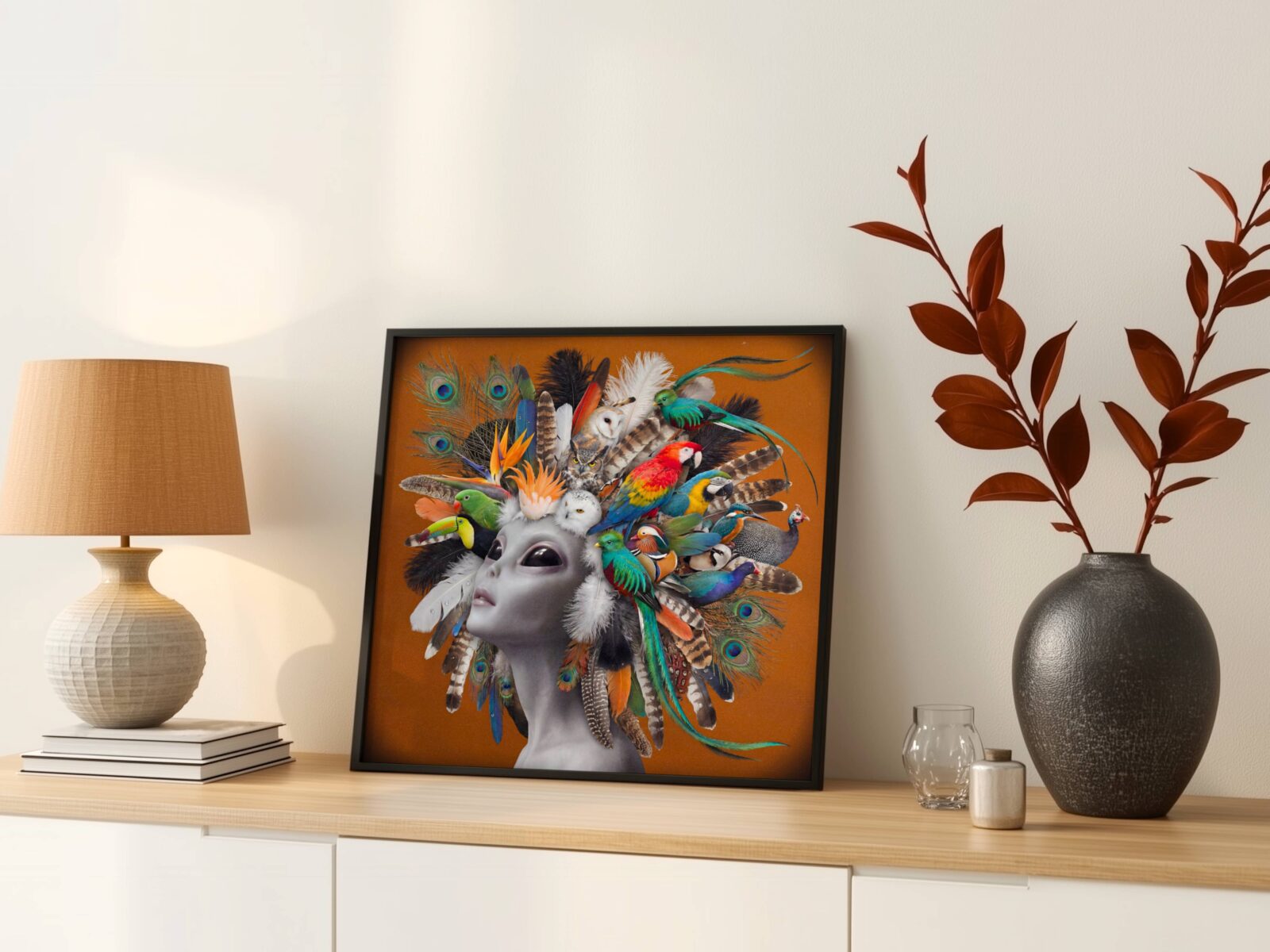 Bold vibrant surreal portrait of a grey alien crowned with an extraordinary gathering of exotic birds — scarlet macaw, toucan, barn owl, mandarin duck and quetzal — peacock feathers and tropical plumage cascading against warm burnt orange — a striking and joyful alien wall art print that brings warmth and wonder to any living room – unframed colourful alien bird poster for living room, ufoposter.com