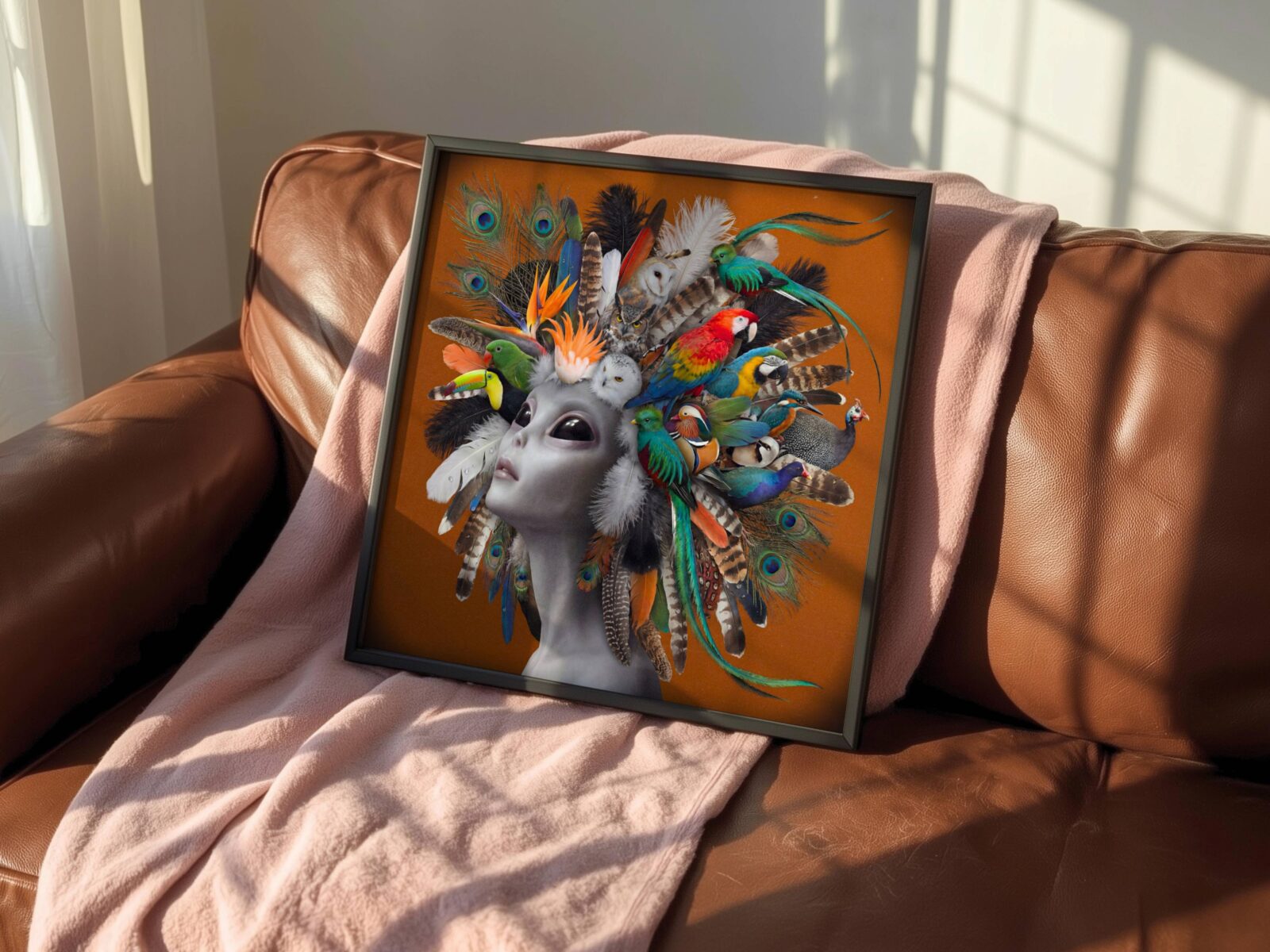 Vibrant surreal portrait of a grey alien wearing a breathtaking living headdress of exotic birds — scarlet macaw, toucan, barn owl, quetzal and mandarin duck — with peacock and tropical feathers cascading against a warm burnt orange background — a bold and distinctive colourful living room wall art print – unframed vibrant alien bird living room poster, ufoposter.com