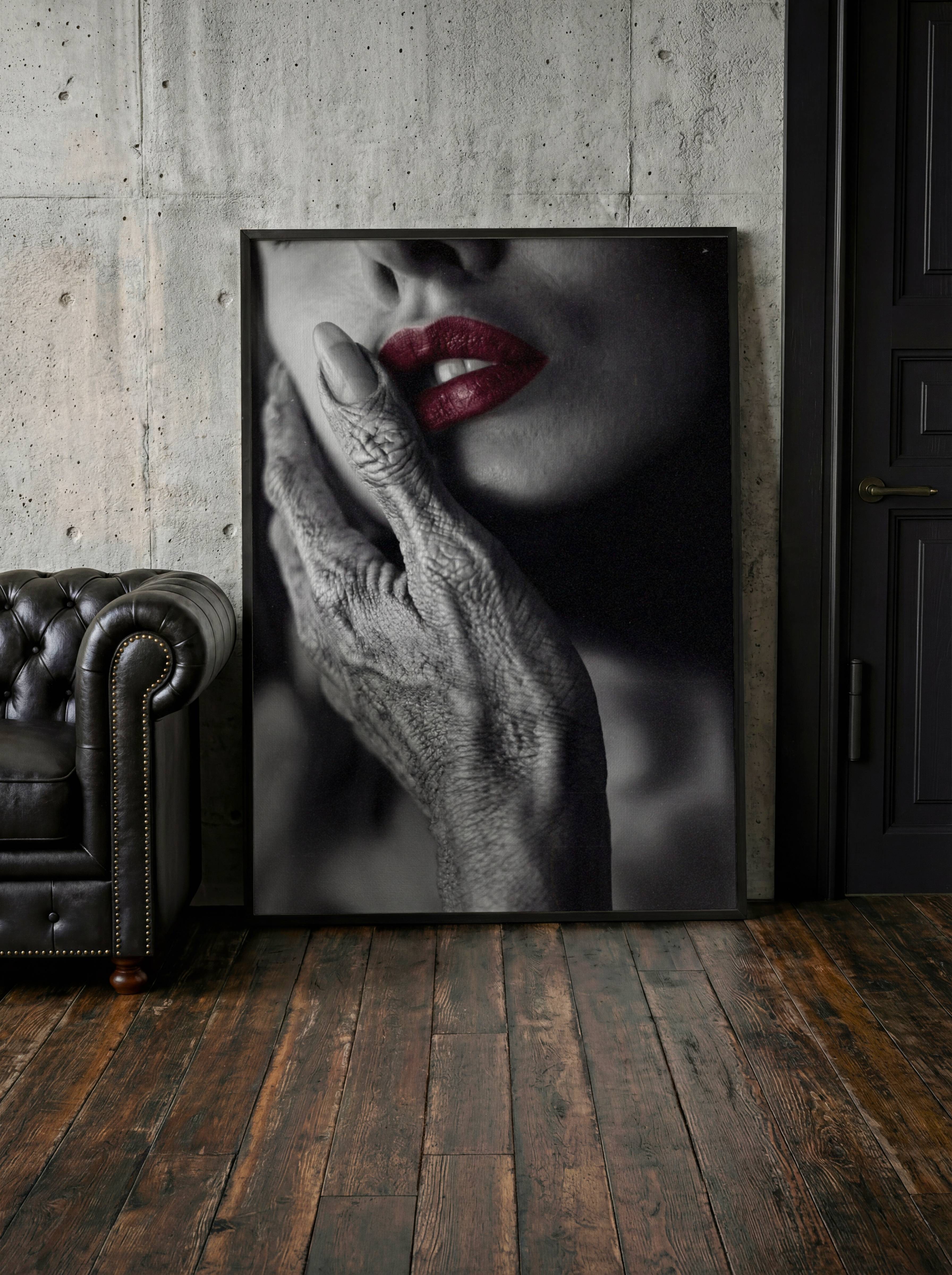 Bold dark monochrome alien portrait close-up of a textured grey alien hand on a woman's cheek with vivid red lips as the only colour accent — a genuinely sophisticated and striking dark wall art statement for any living room – unframed dark alien living room poster, ufoposter.com