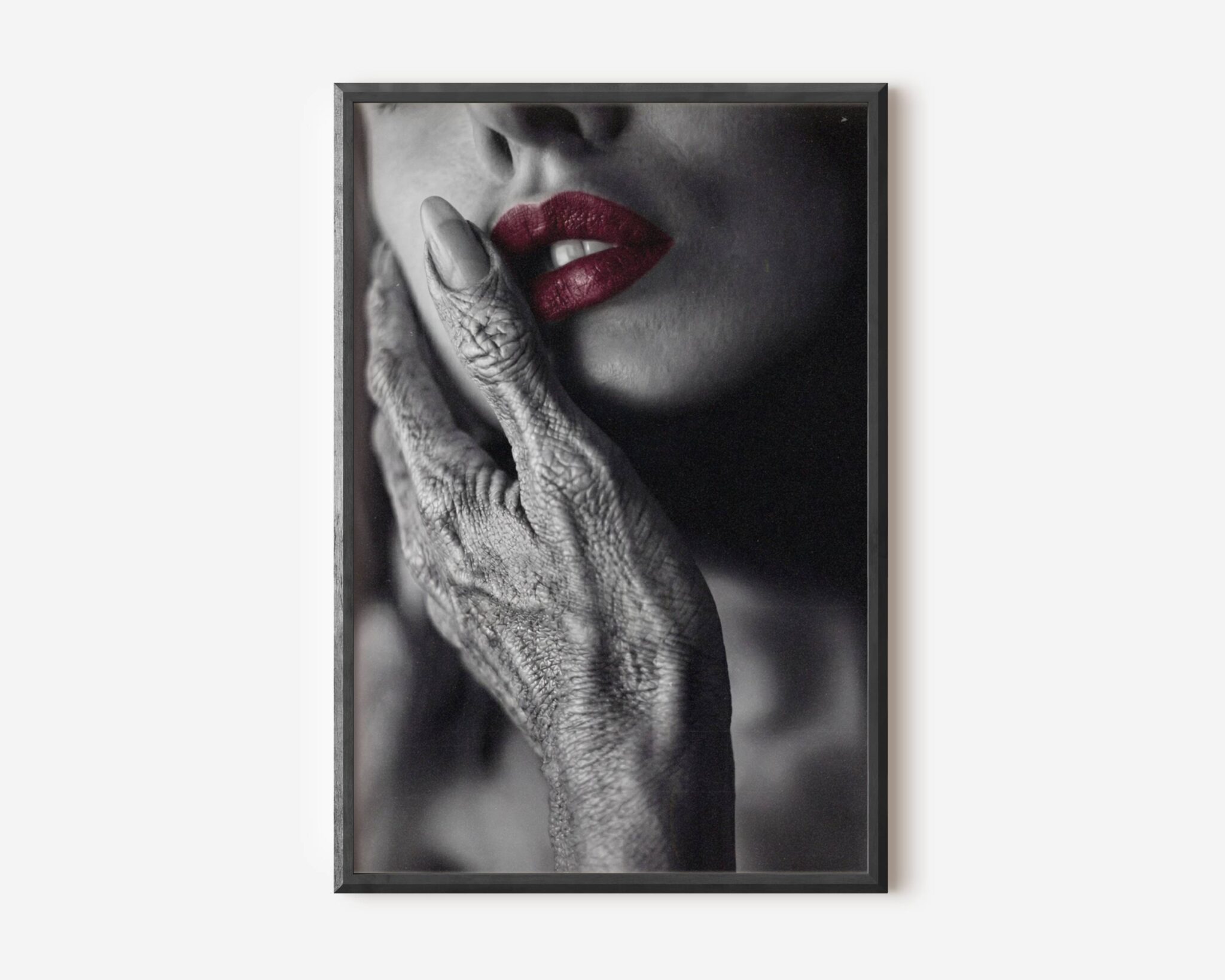 Premium dark monochrome close-up of a textured grey alien hand resting gently against a woman's cheek, her vivid red lips the only colour in an otherwise black and white composition — bold and sophisticated dark alien wall art – unframed dark alien art poster, ufoposter.com