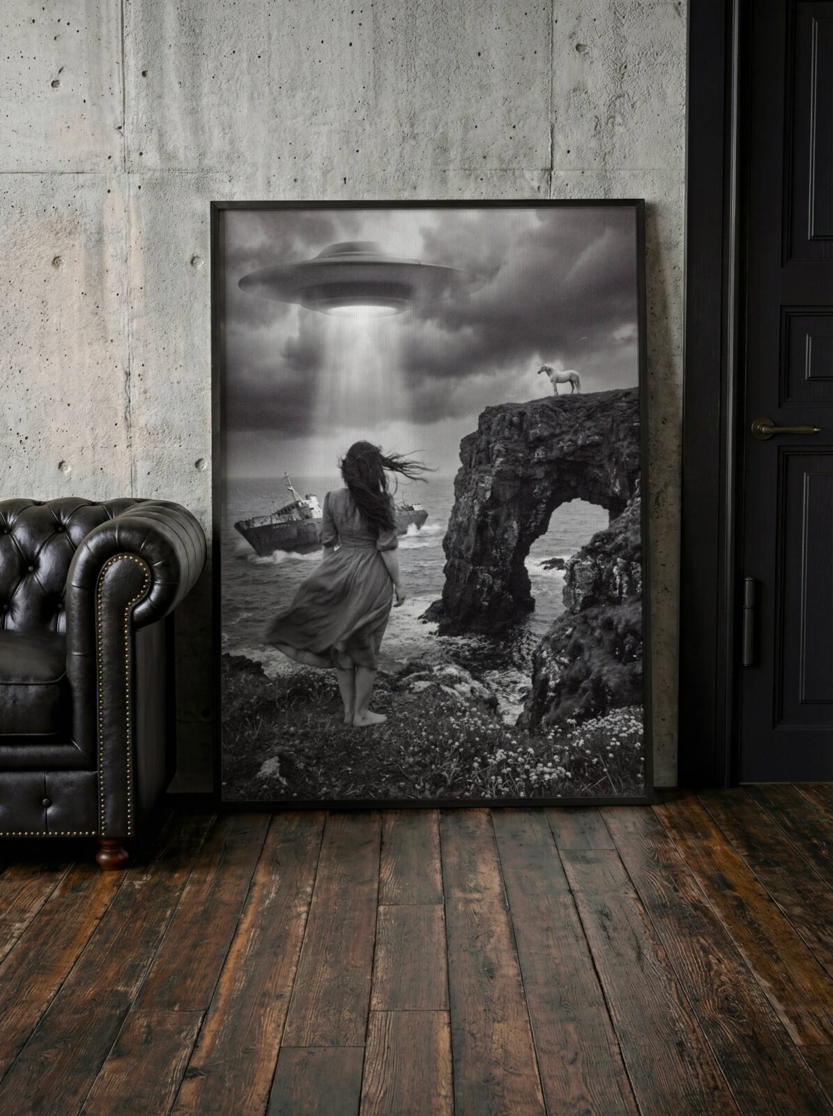 Striking atmospheric black and white surreal artwork of a barefoot woman on a stormy rocky coast with a listing shipwreck in the waves, a UFO casting white light through dark clouds and a unicorn standing on a clifftop arch